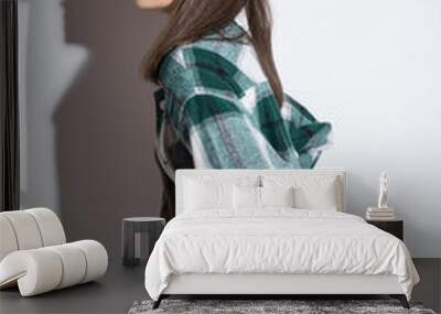 Full-length portrait of a beautiful young girl looking at the camera. Friendly cute girl in a checkered shirt isolated on a white background Wall mural